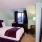 a bedroom with a bed and a chair