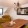 a living room with a yellow couch and a table