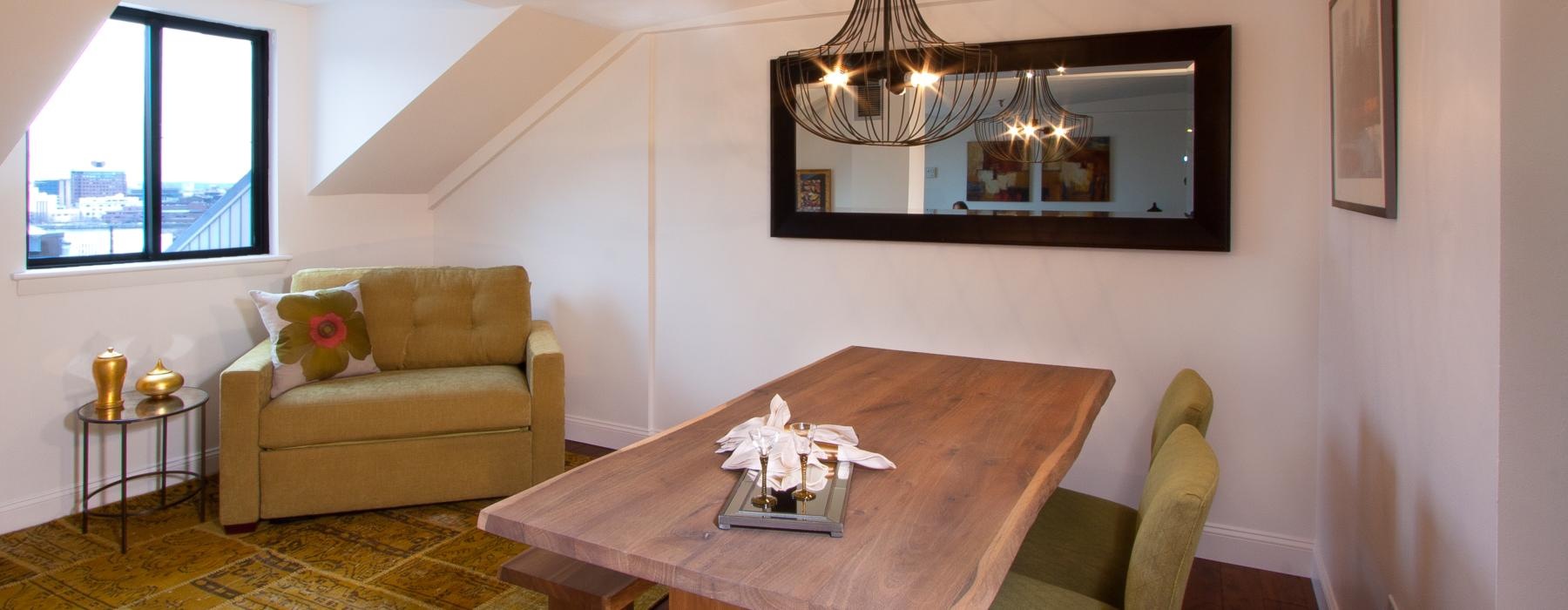 a living room with a table and chairs